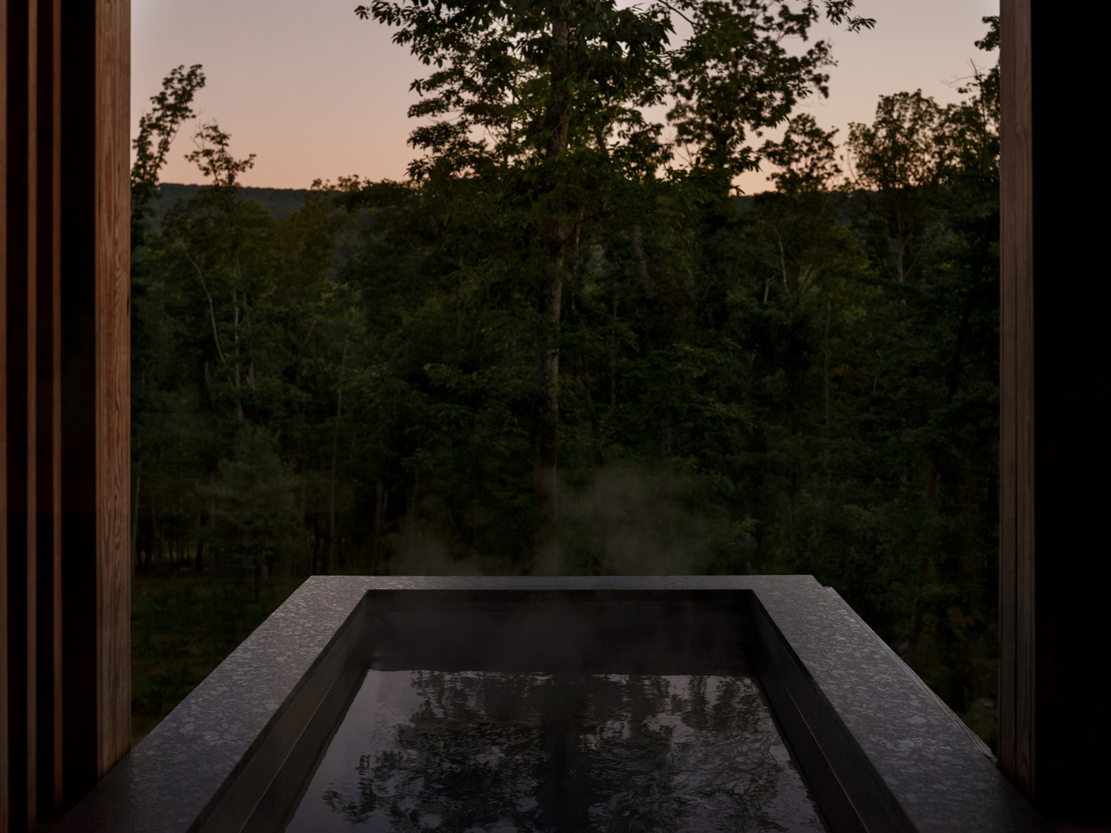 Plunge pool and villa at Será at Sandy Ridge at dusk with forest views